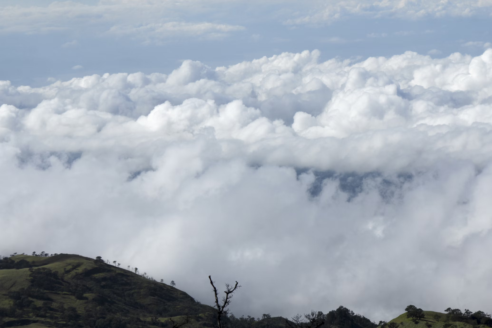 Floating clouds over Badal Danda on the Mardi Himal Trek, showcasing stunning mountain views in Nepal
